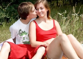 Bella E sucks him off in tall summer grass before they kiss on a towel